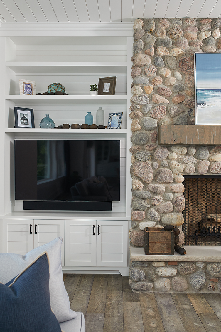 hearth next to a tv inside a beautiful lake front house