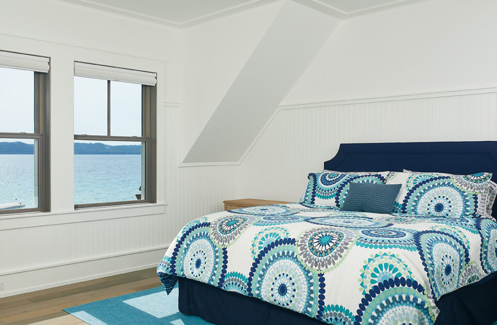 a lake view bedroom inside of a beautiful modern mansion
