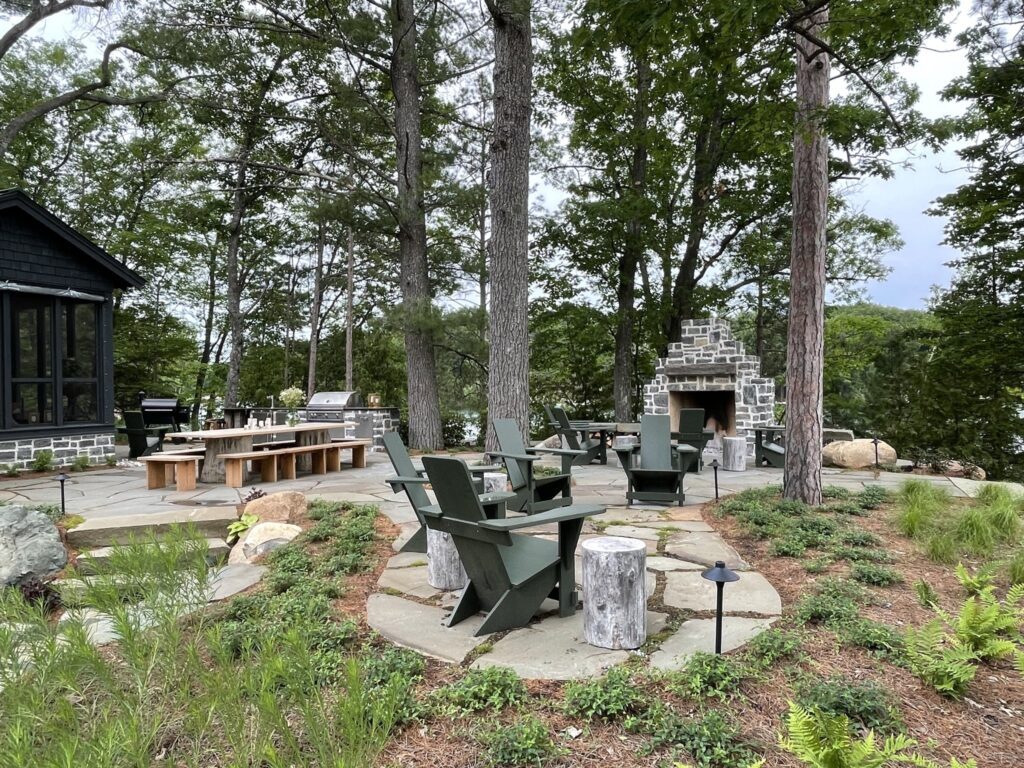 Another view of terrace, chairs, and outdoor fireplace