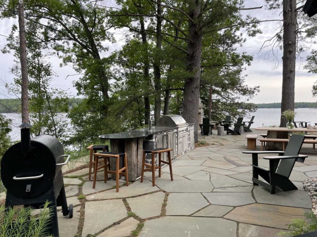 Beautiful lakeside terrace with grill and tables for dining