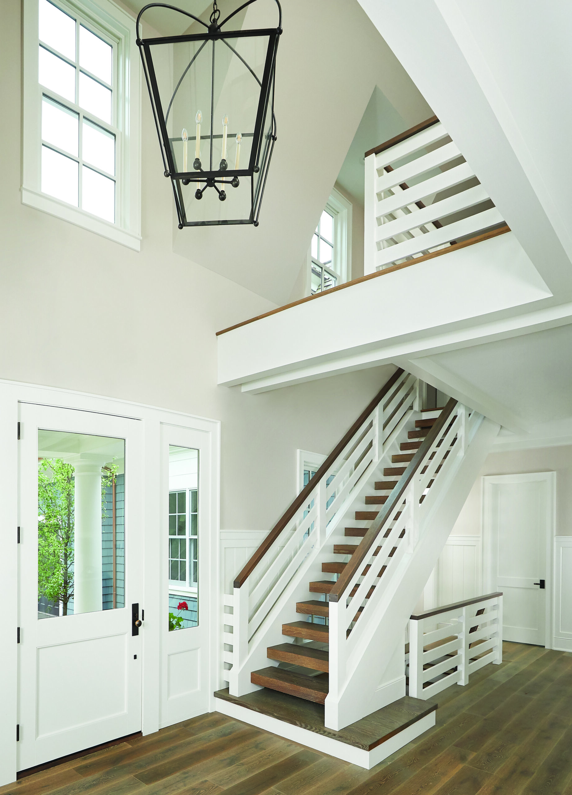 Open timber staircase and upper landing in Glen Arbor home