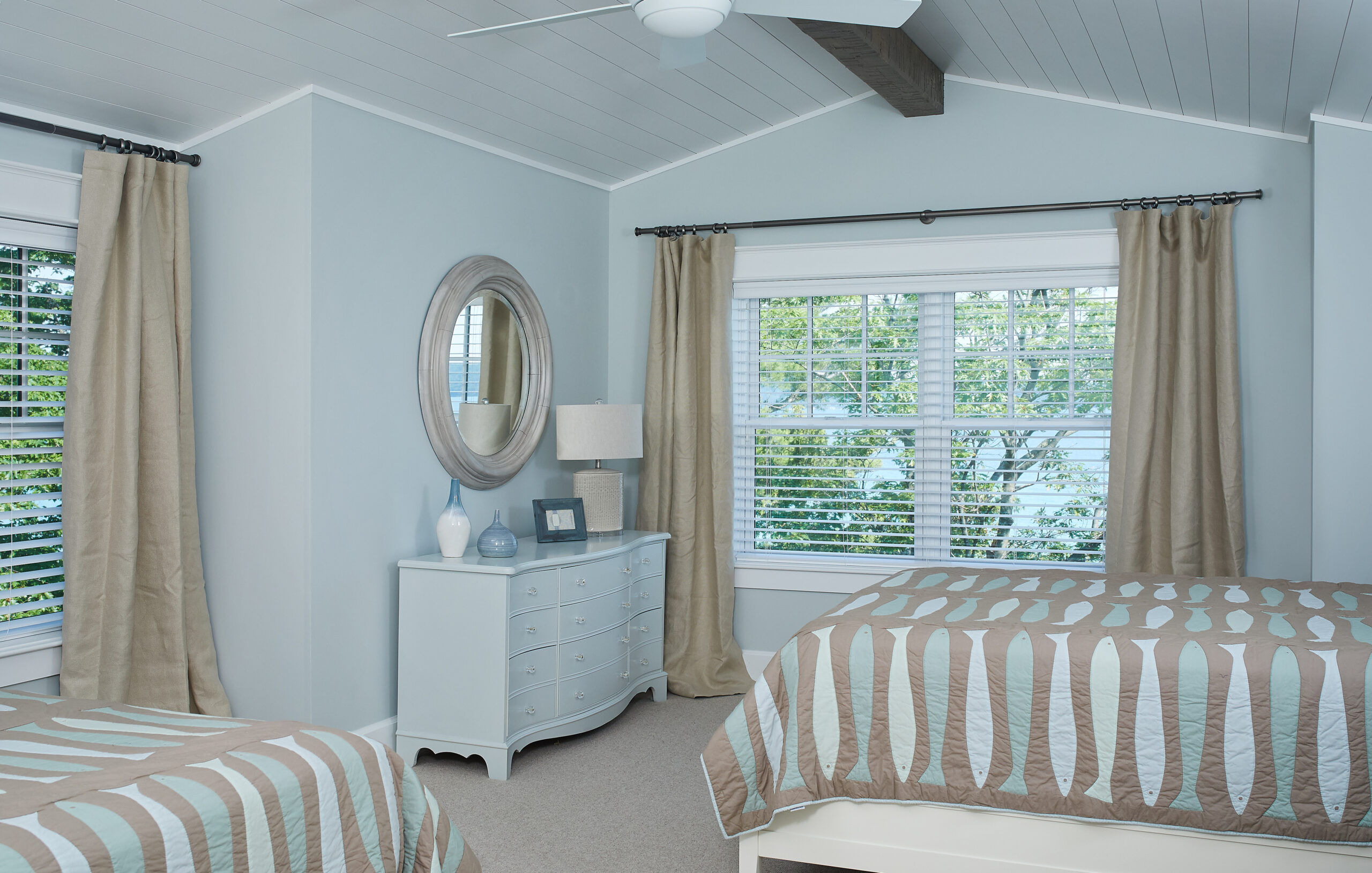 Light blue guest bedroom with twin beds and coastal-inspired decor