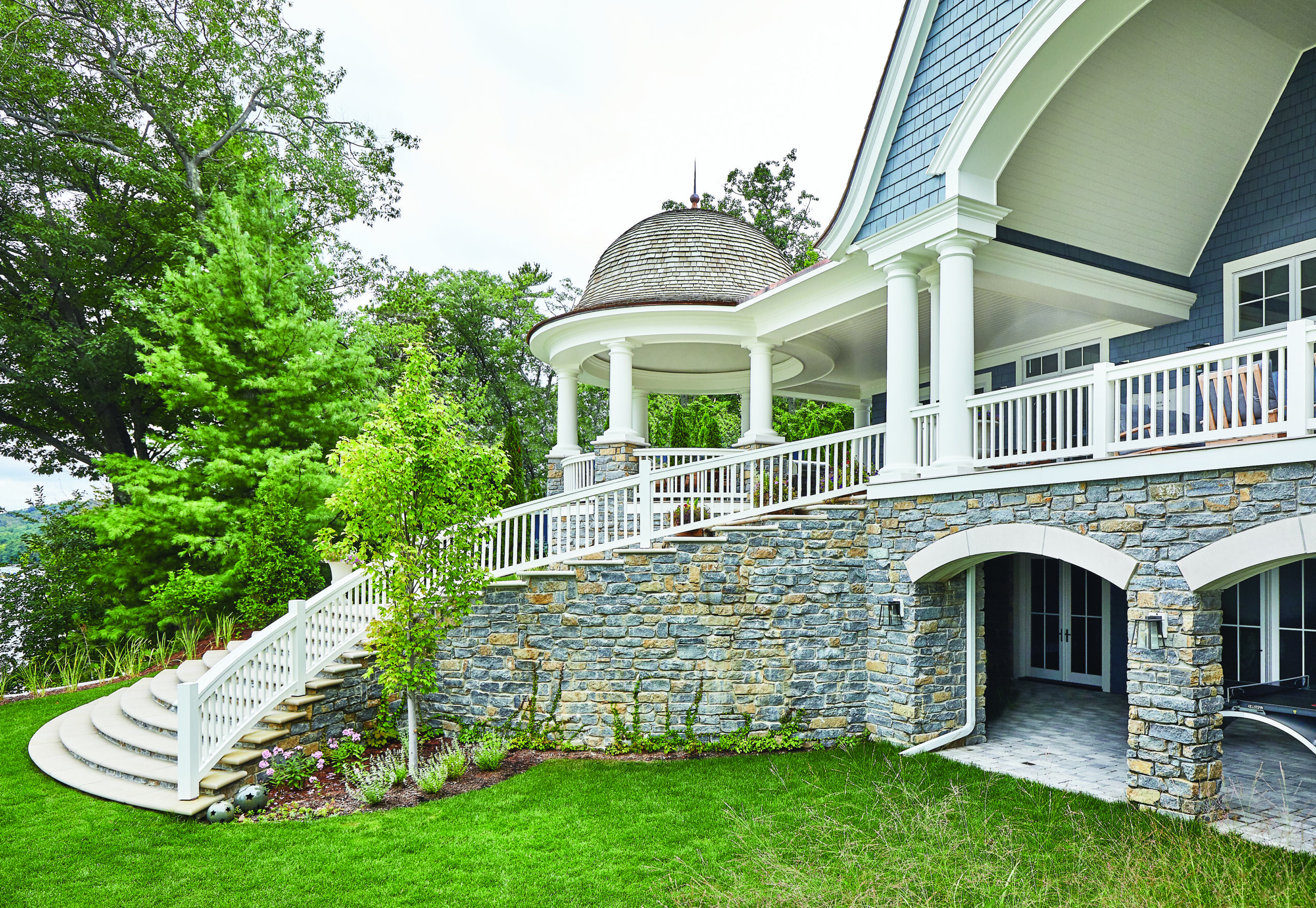 Glen Arbor lake home with curved stone staircase and domed porch roof