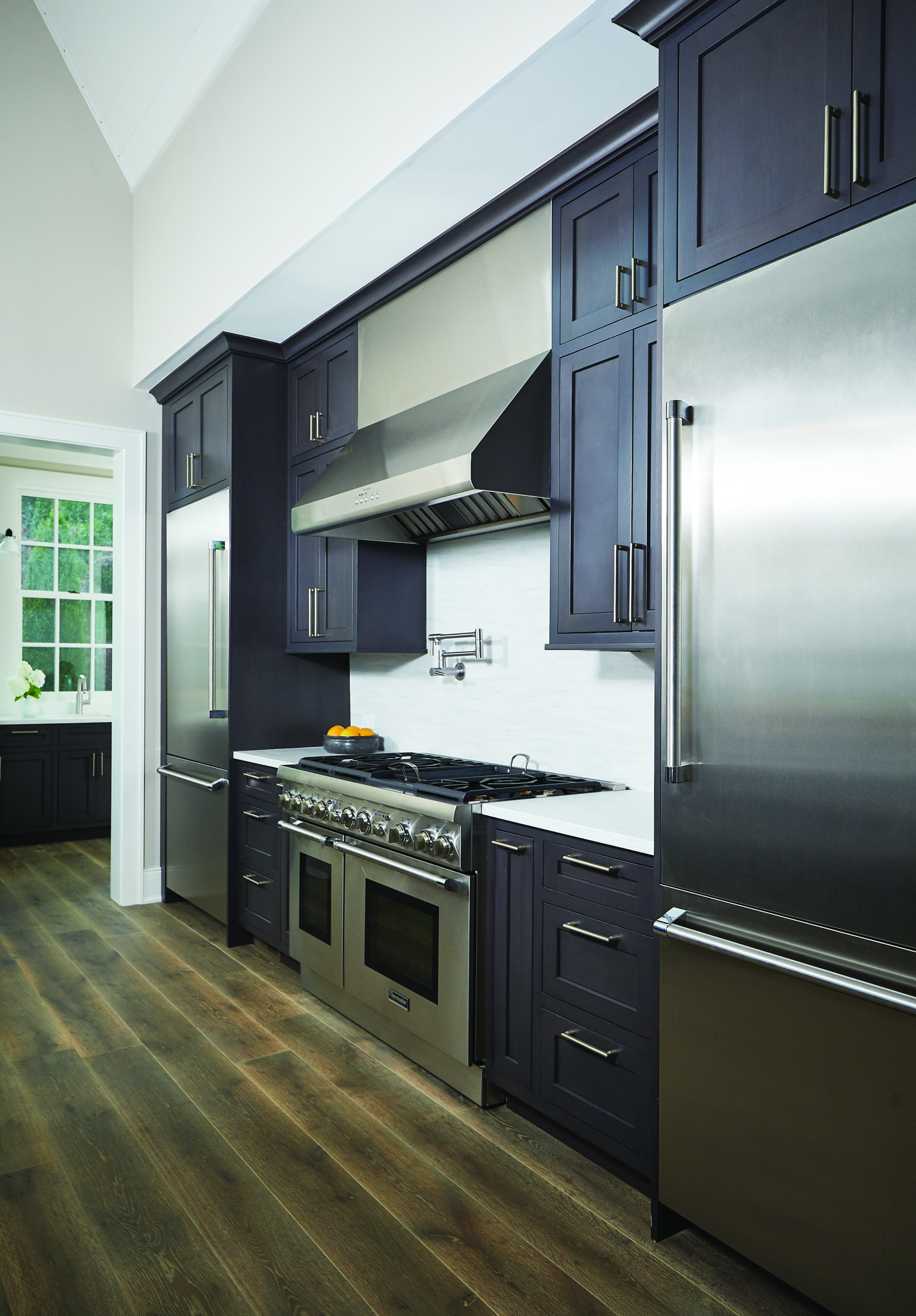 Modern Glen Arbor kitchen with dark cabinetry and stainless steel appliances