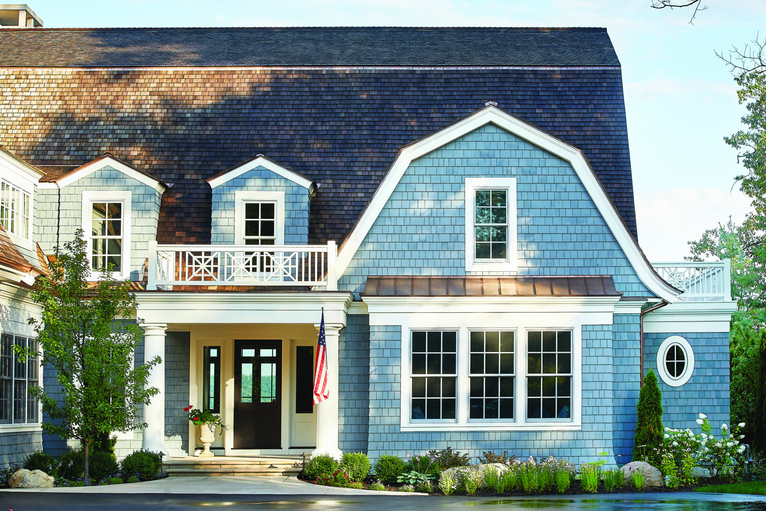 Glen Arbor lake home exterior with blue shingle siding and covered front porch
