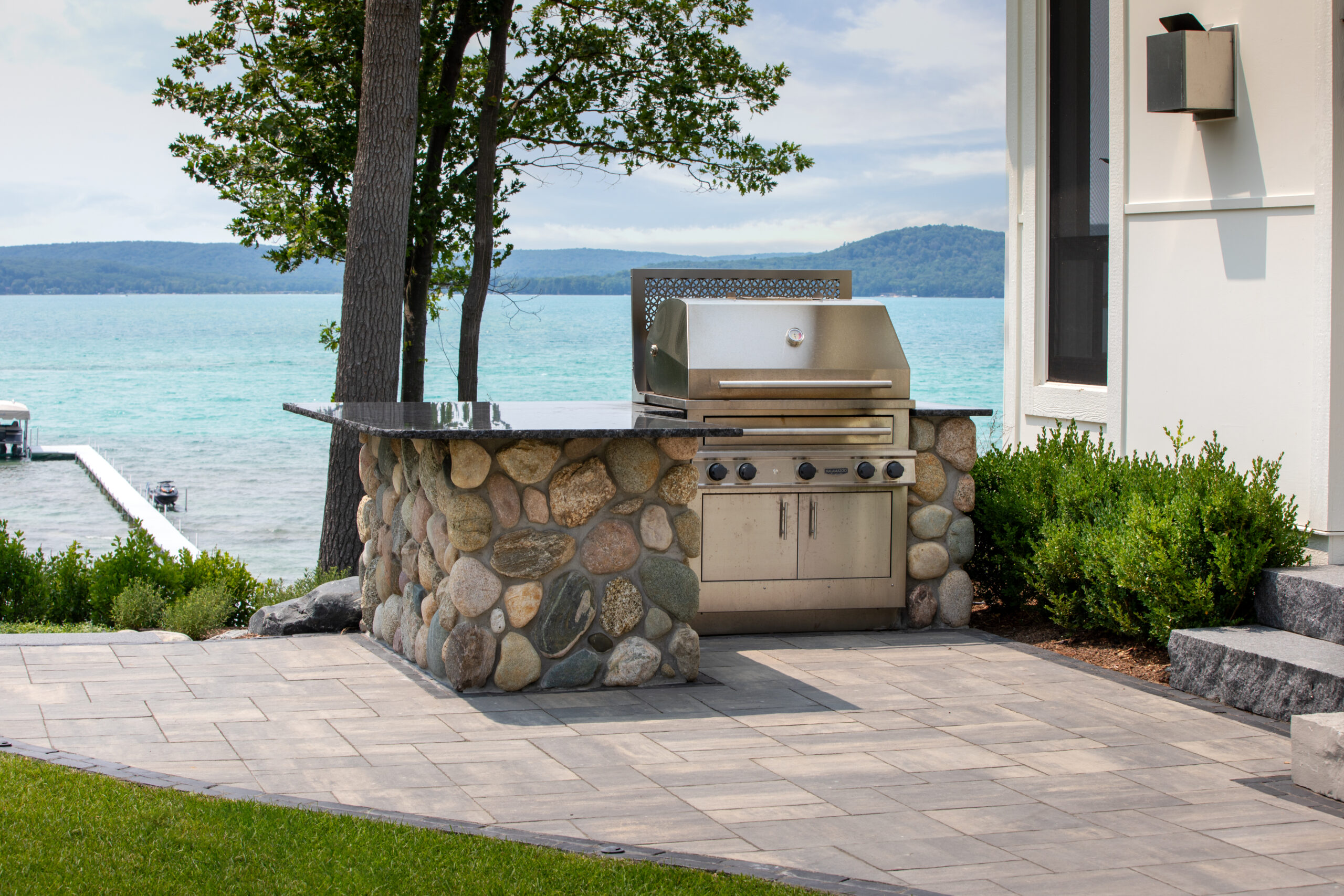 Outdoor stone grill station overlooking the lake