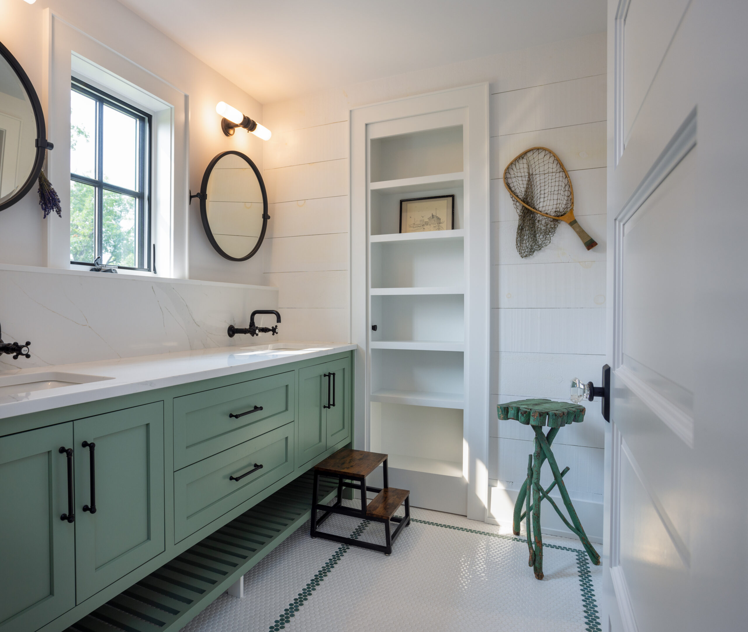 Small bathroom with green vanity and round mirror