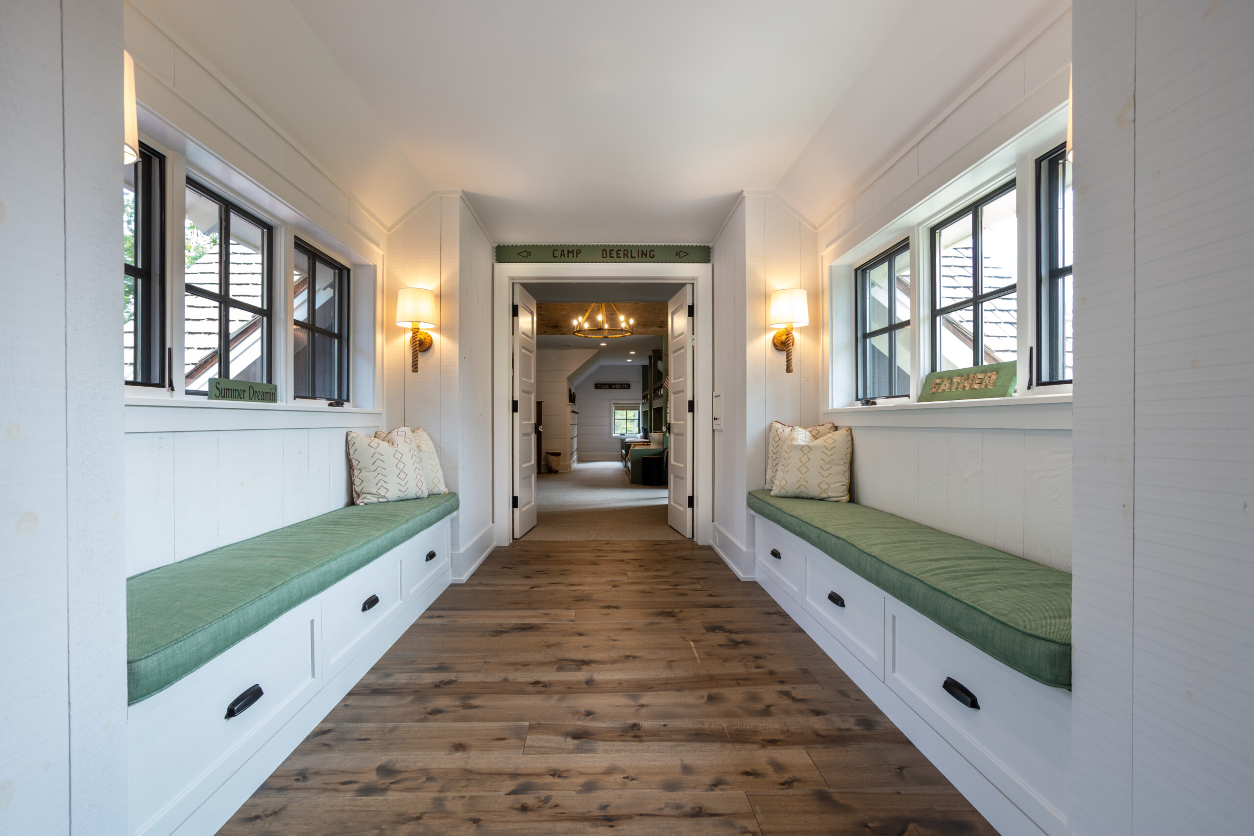 Hallway with built-in bench seating and green cushions