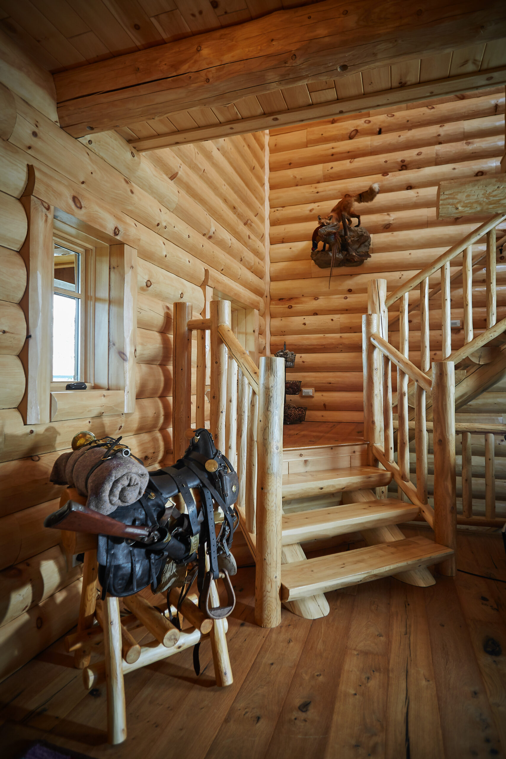 Rustic log cabin staircase with handcrafted wood railings and lodge décor