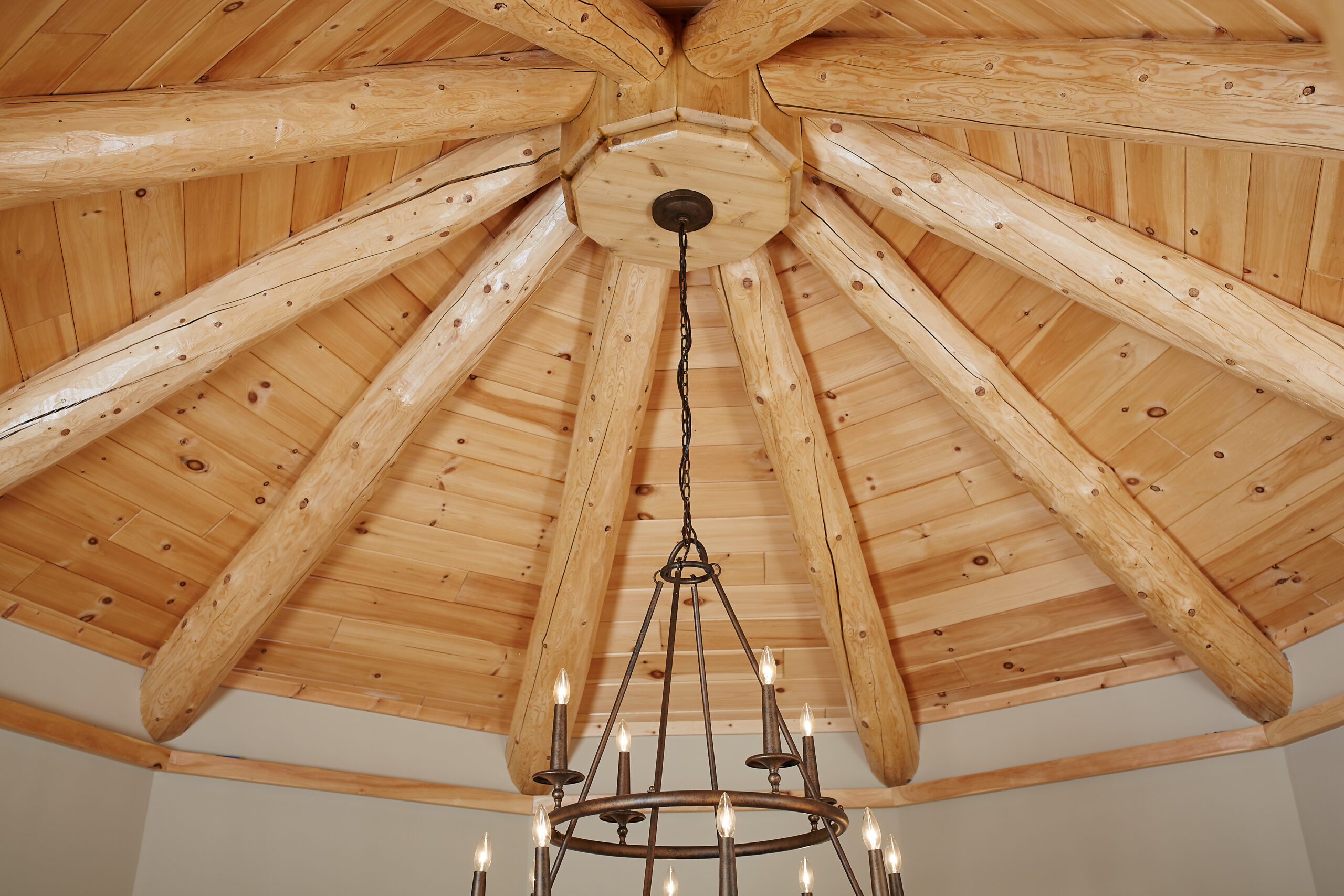 Timber-framed vaulted ceiling with rustic chandelier