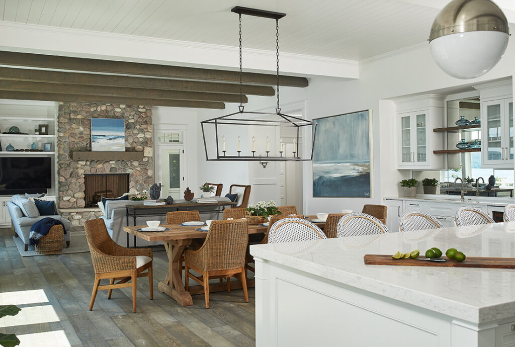 Open-concept dining and living area with stone fireplace