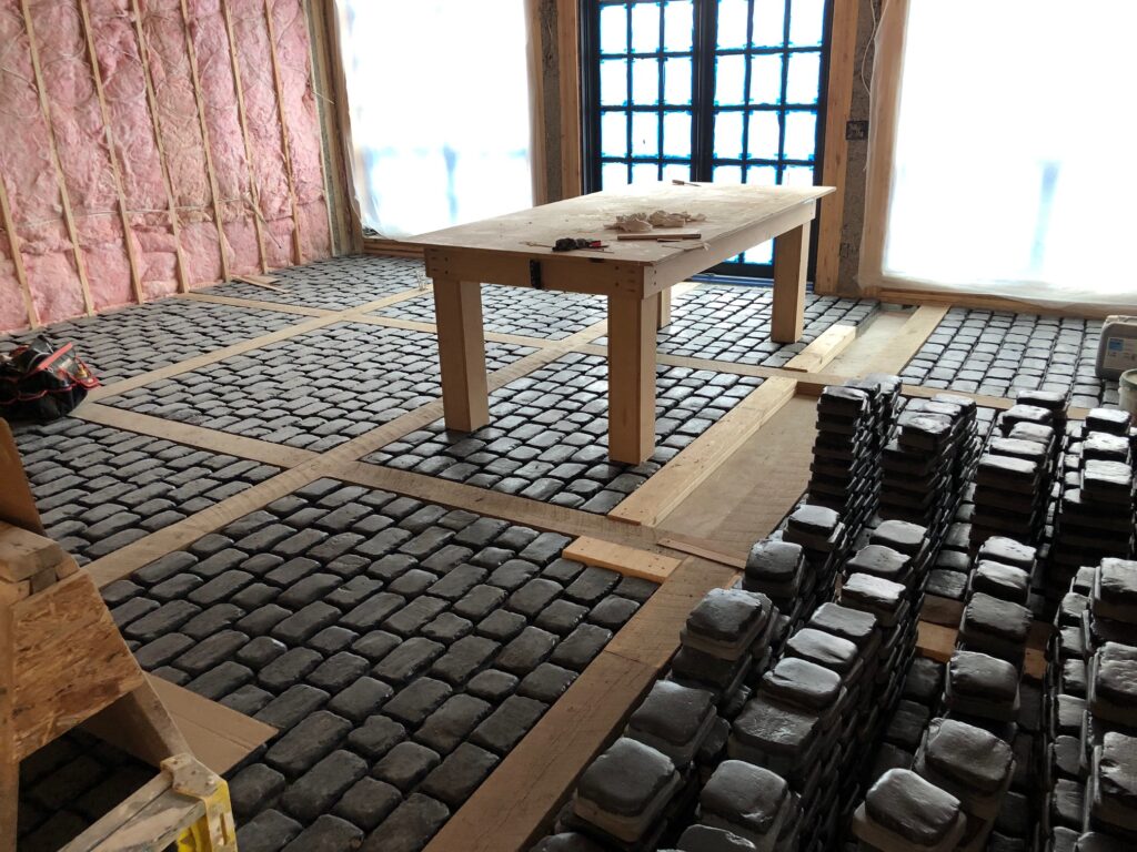 Custom cobblestone floor installation in progress