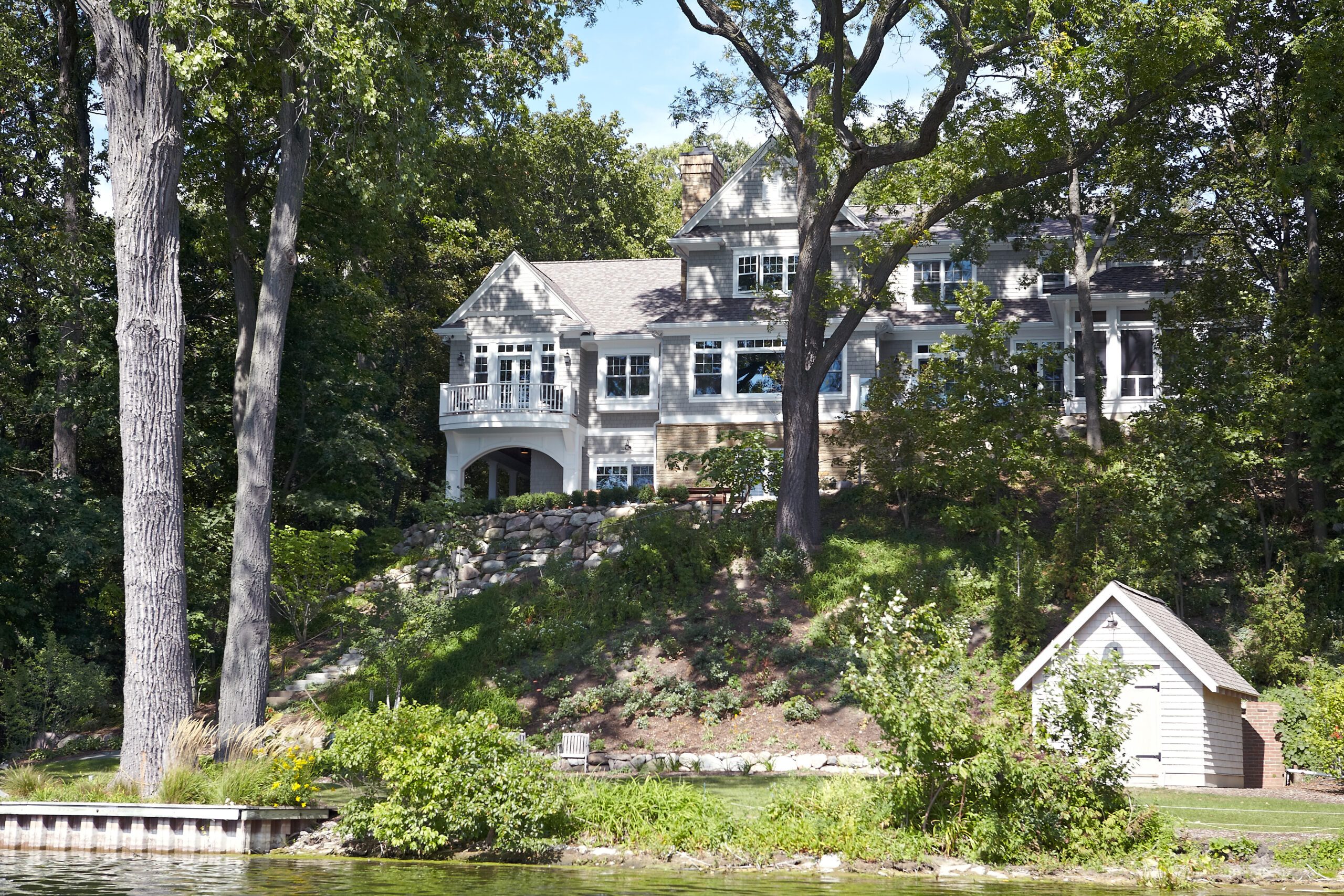 Lakeside cottage home nestled on a wooded hillside overlooking the water