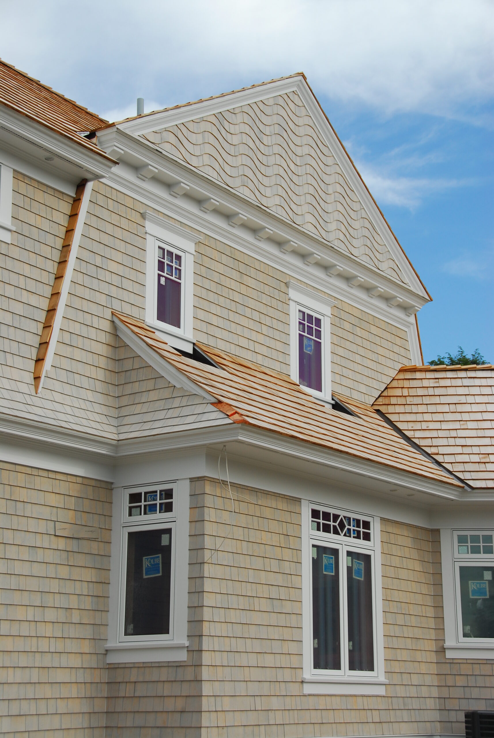Cedar shake home exterior with decorative gable siding and white trim