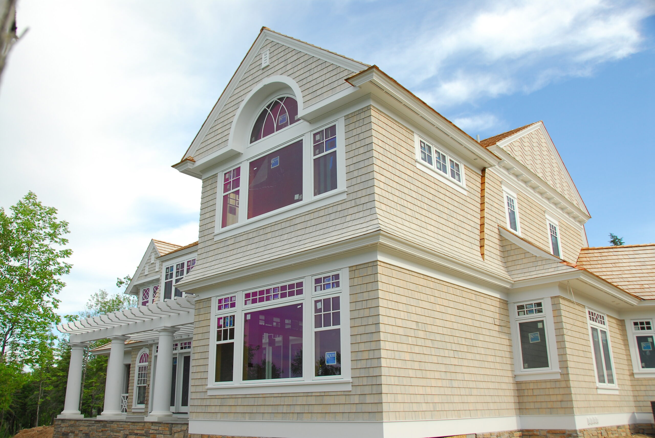 Lakeside home exterior with cedar shake siding and white-trimmed windows