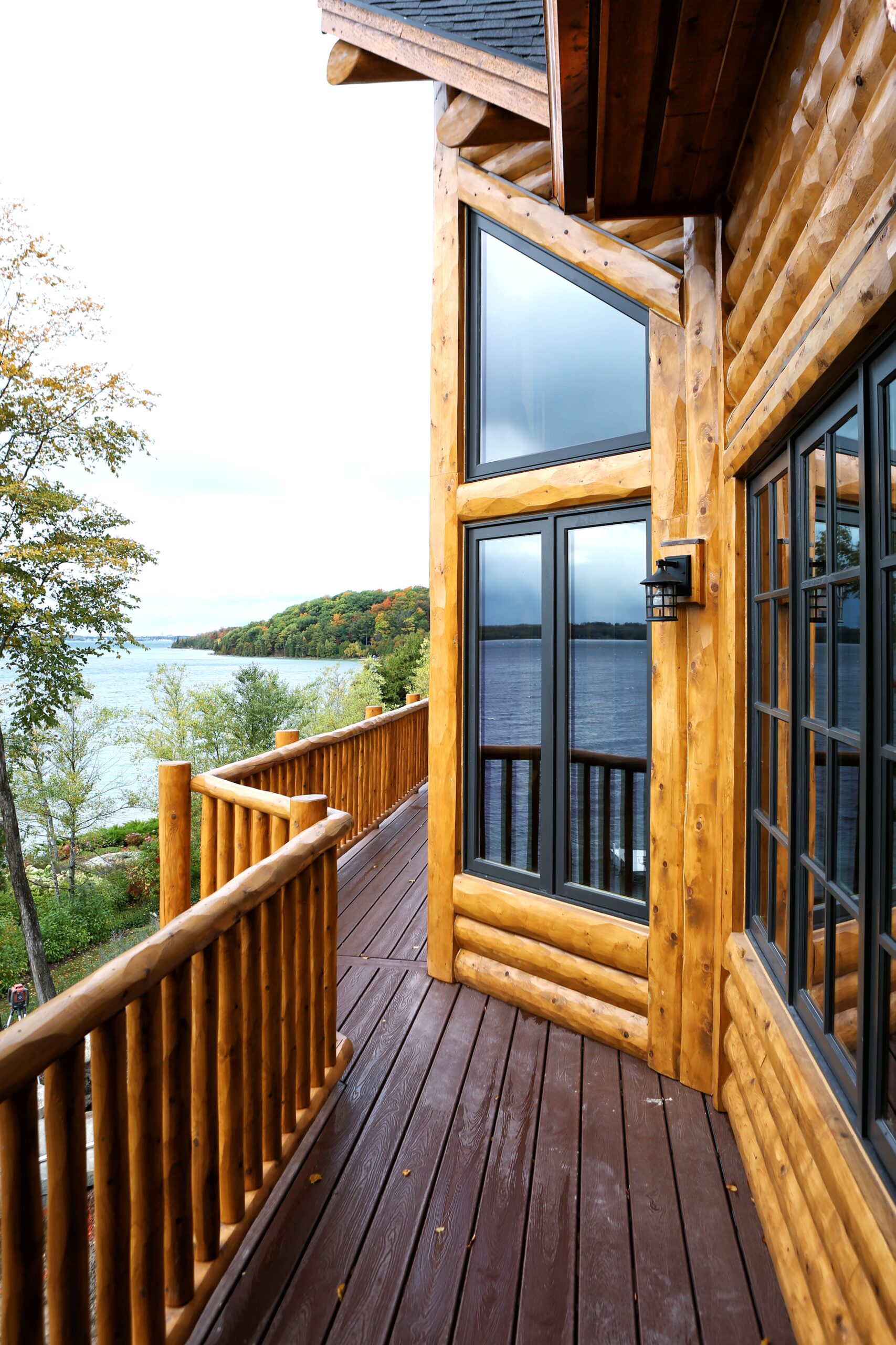 Lake Charlevoix custom home exterior with black windows and elevated deck overlooking lake view